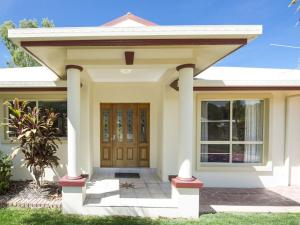 a small house with a wooden door at Island Dreams in Nelly Bay