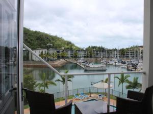 a view of a marina from the balcony of a hotel at Beachside Apartment 17 in Nelly Bay