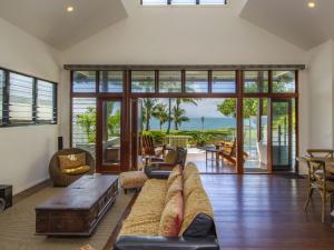 a living room with a couch and a table at Beached on Magnetic in Picnic Bay