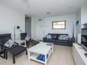 a living room with a couch and chairs at 1 Bright Point Apartment 5102 in Nelly Bay