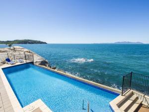 a swimming pool with the ocean in the background at 1 Bright Point Apartment 5102 in Nelly Bay