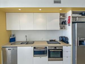 A kitchen or kitchenette at 1 Bright Point Apartment 2305
