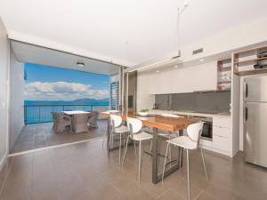 a kitchen and dining room with a view of the ocean at 1 Bright Point Apartment 4501 in Nelly Bay