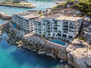 an aerial view of a building on a rocky cliff at 1 Bright Point Apartment 4501 in Nelly Bay