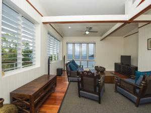 a living room with a table and chairs at Driftwood in Picnic Bay