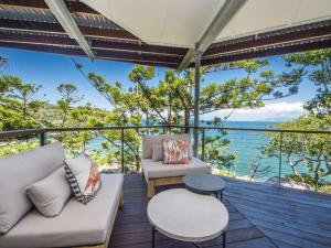 a living room with a view of the ocean at Headland House in Picnic Bay