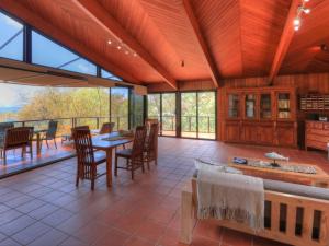 an open living room with a table and chairs at The Beach House at Arthur Bay in Horseshoe Bay