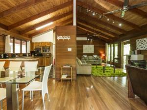 a kitchen and living room with a glass table and chairs at Magnetic Effect in Arcadia