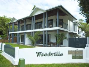 a house with a woodville sign in front of it at Woodville Beach Townhouse 6 in Arcadia