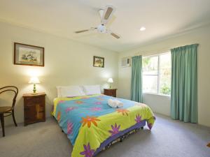 a bedroom with a bed and a window at Johns Tropical Island Home in Nelly Bay