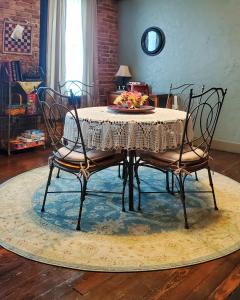 a dining room table with two chairs on a rug at Guest Apartment at Commercial Street Studio in Lebanon