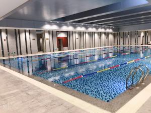 a large swimming pool in a building at Binhai Jinling International Hotel in Binhai