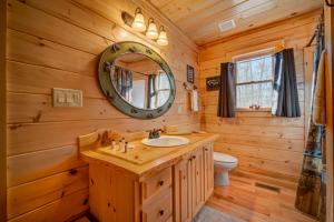 a bathroom with a sink and a mirror at Can't Bear To Leave in Morganton +36 photos