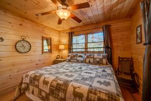 a bedroom with a bed in a log cabin at Can't Bear To Leave in Morganton