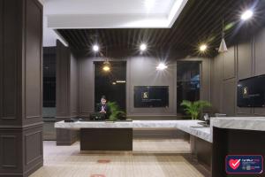 a man sitting at a desk in an office at Sentral Cawang Hotel in Jakarta