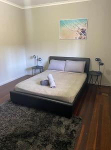 a bed with two pillows on it in a room at Backpackers In Paradise 18-35 Hostel in Gold Coast
