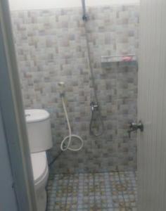 a bathroom with a shower with a toilet at Villa Asri in Batu