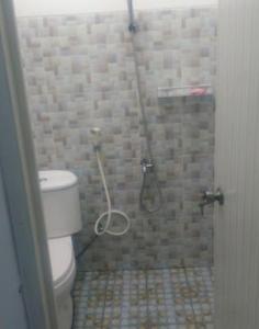 a bathroom with a shower with a toilet at Villa Asri in Batu