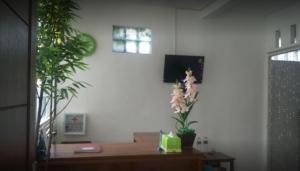 a living room with a table and some plants at Villa Asri in Batu
