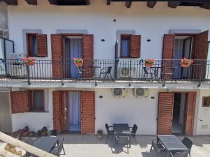a building with tables and chairs on a balcony at Astra in Agerola