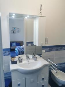 a bathroom with a white sink and a mirror at Astra in Agerola