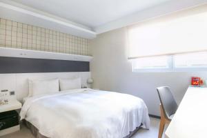 Postel nebo postele na pokoji v ubytování Dandy Hotel - Tianmu Branch