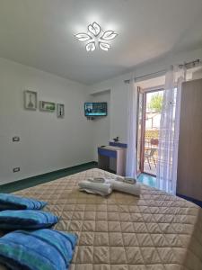 a bedroom with a large bed with two pillows on it at Astra in Agerola