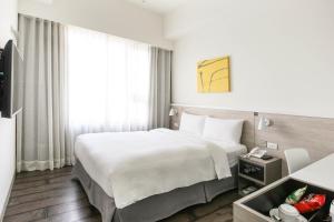Letto o letti in una camera di CityInn Hotel Plus- Fuxing North Road Branch