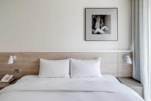Letto o letti in una camera di CityInn Hotel Plus- Fuxing North Road Branch