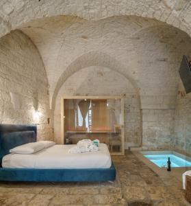 a bedroom with a bed and a swimming pool at Dama Bianca Boutique Hotel Ostuni in Ostuni