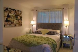 a bedroom with a bed with a large window at Stylish 2-Bed Home, Stunning View, Fire Pit, Festoon Lights, BBQ and walk to Pub in Poowong