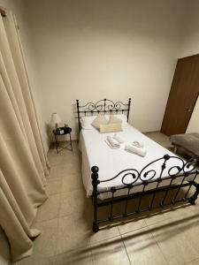 a bedroom with a bed with a black frame at Pramateftis House in Agros