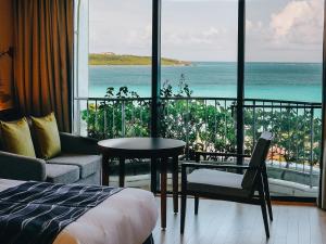 a room with a bed and a view of the ocean at Miyakojima Tokyu Hotel & Resorts in Miyako-jima