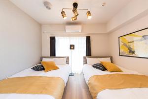 Postel nebo postele na pokoji v ubytování SG RESIDENCE INN HAKATA