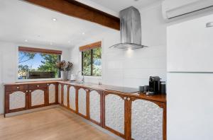a kitchen with white walls and a counter top at Stylish 2-Bed Home, Stunning View, Fire Pit, Festoon Lights, BBQ and walk to Pub in Poowong