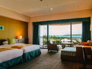 a hotel room with two beds and a balcony at Miyakojima Tokyu Hotel & Resorts in Miyako-jima