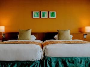 two beds sitting next to each other in a room at Miyakojima Tokyu Hotel & Resorts in Miyako-jima