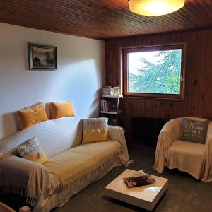 a living room with a couch and a window at The View Fellering in Fellering