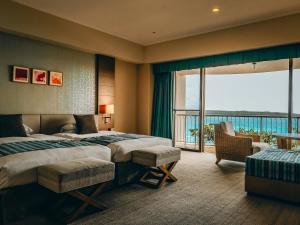 a hotel room with two beds and a balcony at Miyakojima Tokyu Hotel & Resorts in Miyako-jima