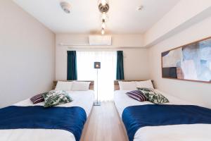 Postel nebo postele na pokoji v ubytování SG RESIDENCE INN HAKATA