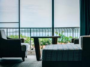 a room with a table and chairs and a window at Miyakojima Tokyu Hotel & Resorts in Miyako-jima