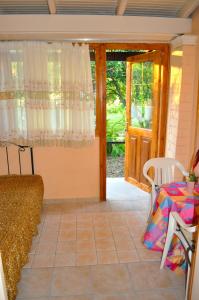 a living room with a table and a glass door at Beachfront holiday Houses Yannis on Agios Gordios beach in Agios Gordios