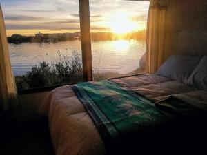 - une chambre avec une fenêtre offrant une vue sur le lac dans l'établissement Room in Lodge - Lucsay Titicaca Lodge, à Puno