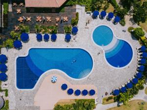 an overhead view of a swimming pool with lounge chairs and a resort at Miyakojima Tokyu Hotel & Resorts in Miyako-jima +37 photos