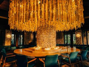 a dining room with a table and a chandelier at Miyakojima Tokyu Hotel & Resorts in Miyako-jima