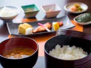 a table with a bowl of soup and a plate of food at Miyakojima Tokyu Hotel & Resorts in Miyako-jima
