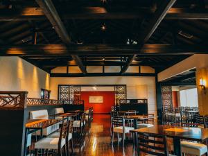 a dining room with wooden tables and chairs at Miyakojima Tokyu Hotel & Resorts in Miyako-jima