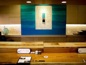 a table in a room with a picture of water at Miyakojima Tokyu Hotel & Resorts in Miyako-jima