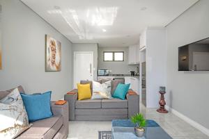 a living room with a couch and a table at Sea De La Vie 25 by HostAgents in La Mercy