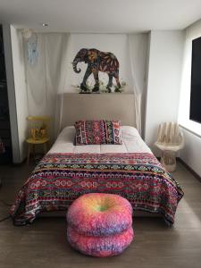 ein Schlafzimmer mit einem Bett und einer Elefanten-Statue an der Wand in der Unterkunft Bogota Calle 105 Norte - Loft Entero in Bogotá